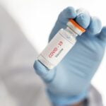 close-up-doctor-holding-vaccine-recipient-her-hand